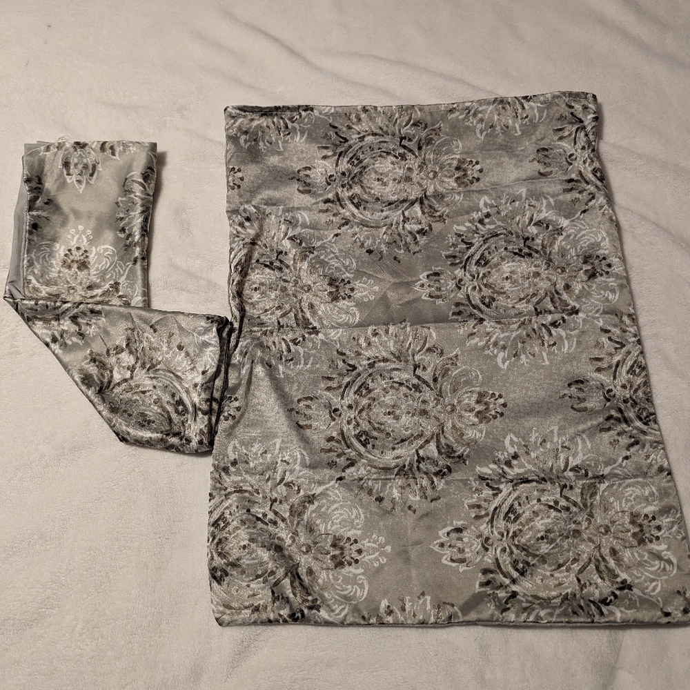 Set on 2 satin pillow cases. Floral. Neutral tones. Flap closure at opening.